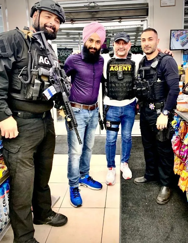 A group of men are posing for a picture in a store.